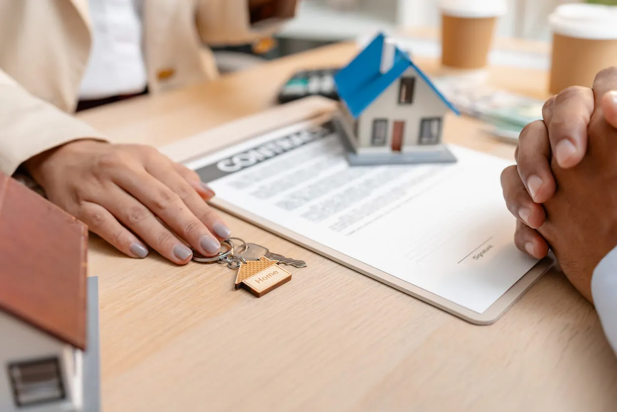 A homeowner reviewing an insurance policy at a kitchen table