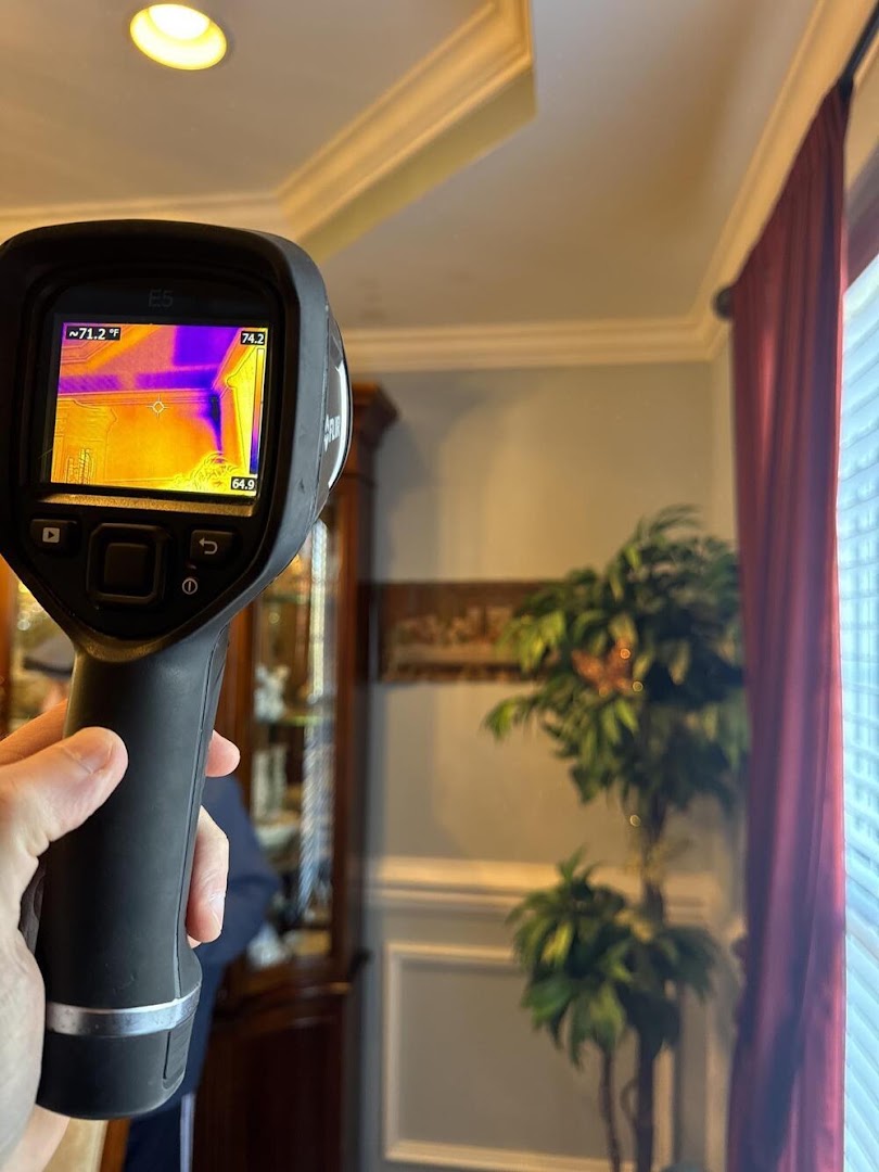 FLIR thermal camera scanning the ceiling line of a finished room